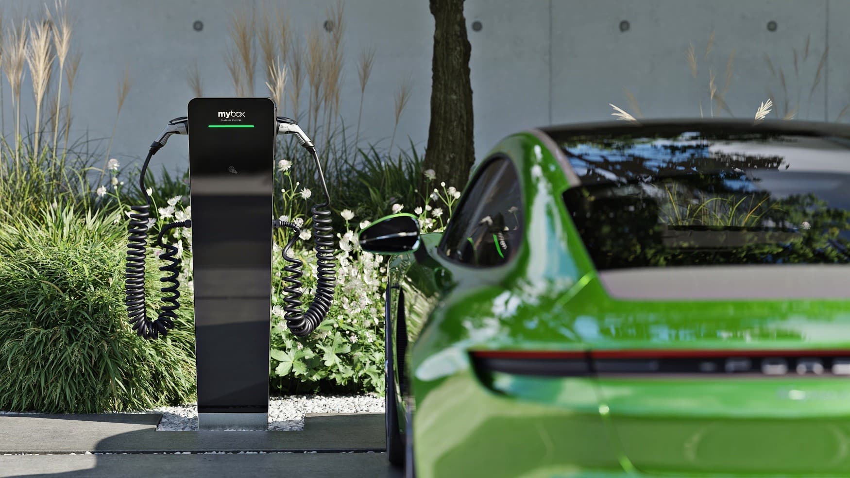 MyBox Post charging pillar by a building entrance, with an electric car parked next to it